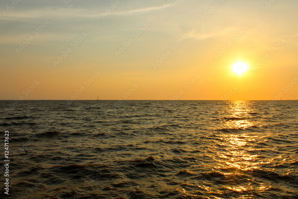 Sunset over sea water.