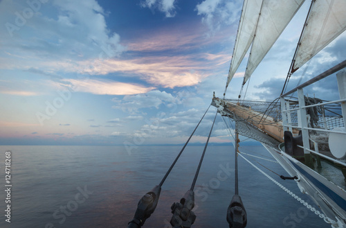 Fotobehang The nose of a sailing ship at sunrise