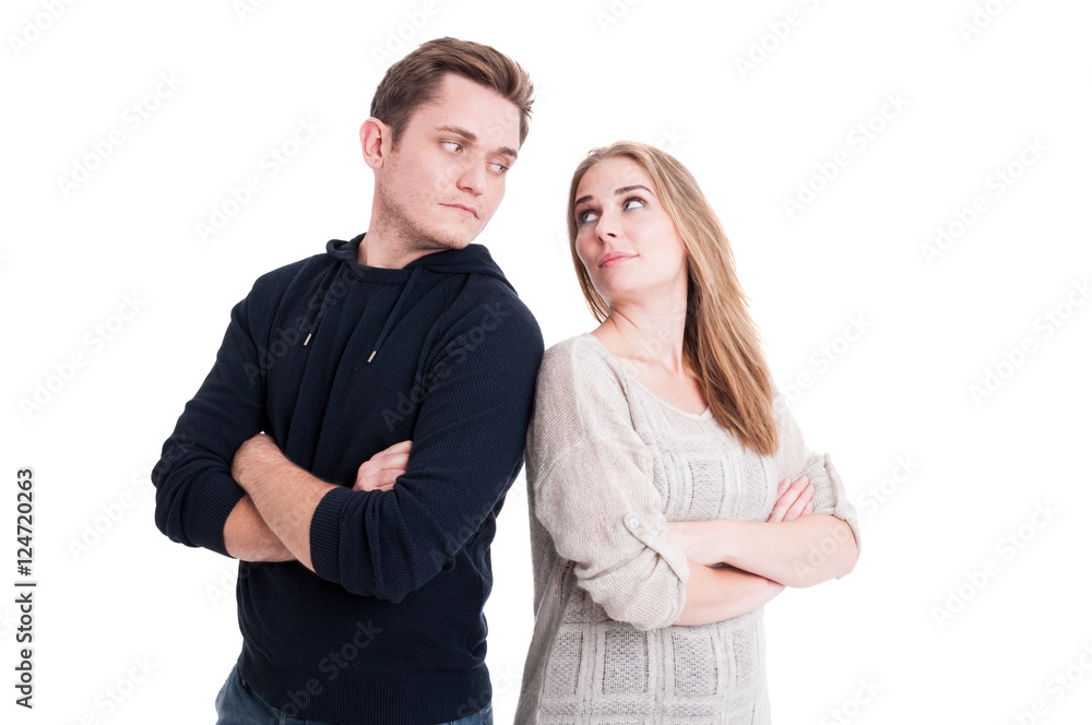 Couple looking at each other with arms crossed Couple looking at each other with arms crossed