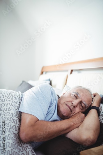 Senior man sleeping on bed