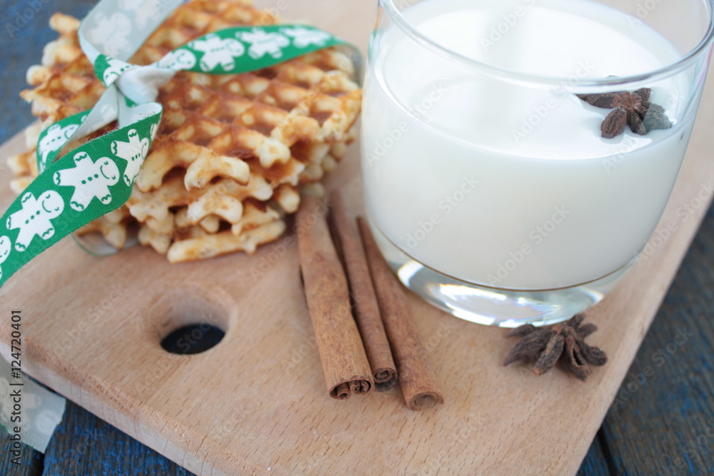 waffles with milk, cinnamon, anise on blue wooden background. a magical dessert for Christmas waffles with milk, cinnamon, anise on blue wooden background. a magical dessert for Christmas