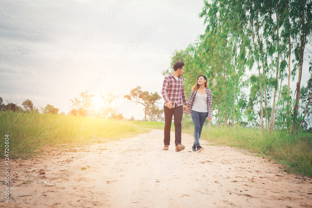 Young hipster couple walking on rural road enjoying with nature, Young hipster couple walking on rural road enjoying with nature,