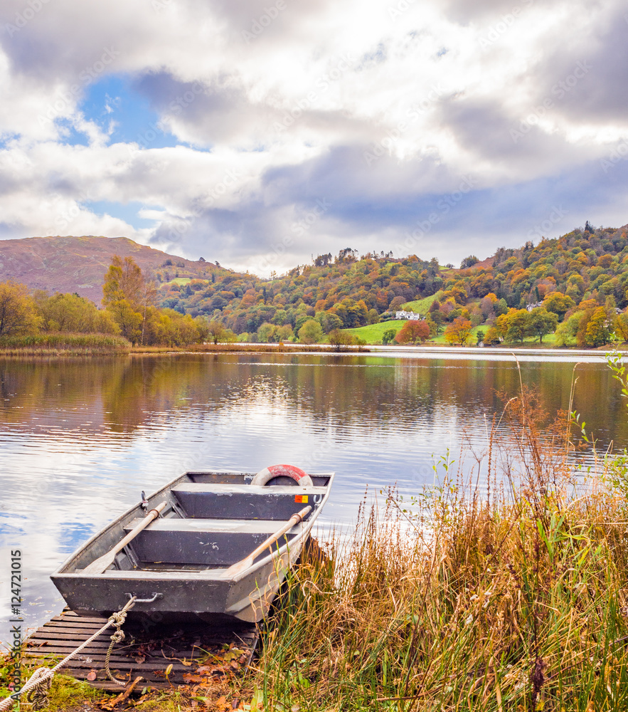 Flat bottomed rowing boat on Lake Grasmere in Autumn, Cumbria, UK Stock