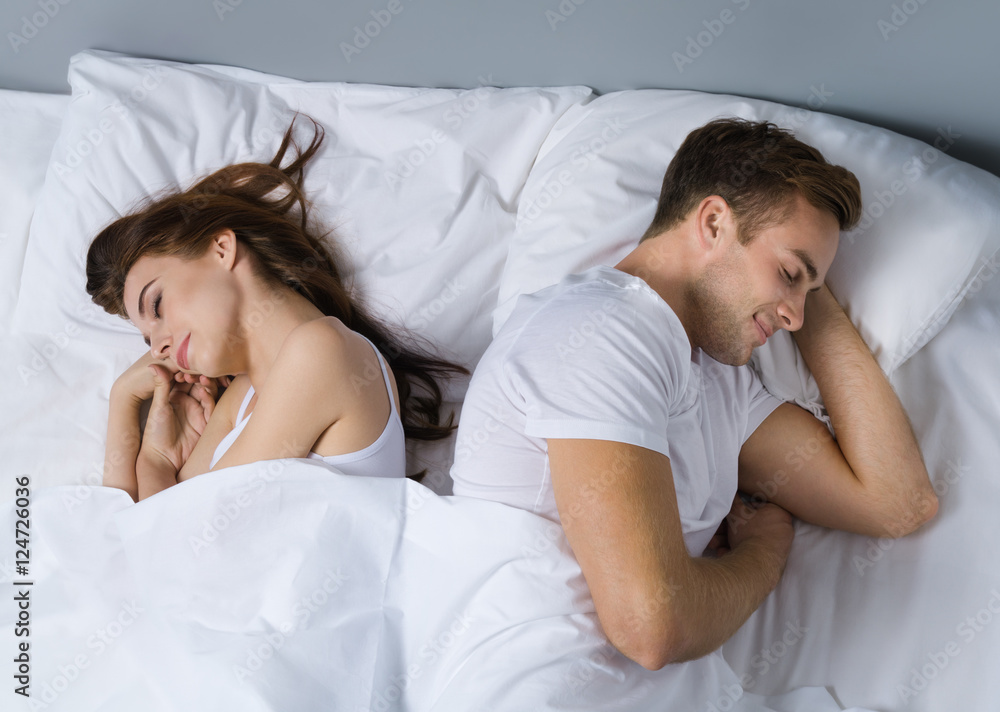 Young couple on the bed in bedroom Young couple on the bed in bedroom