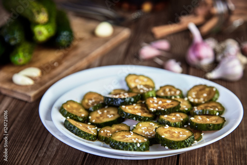 Slices of pickled cucumbers with sesame seeds