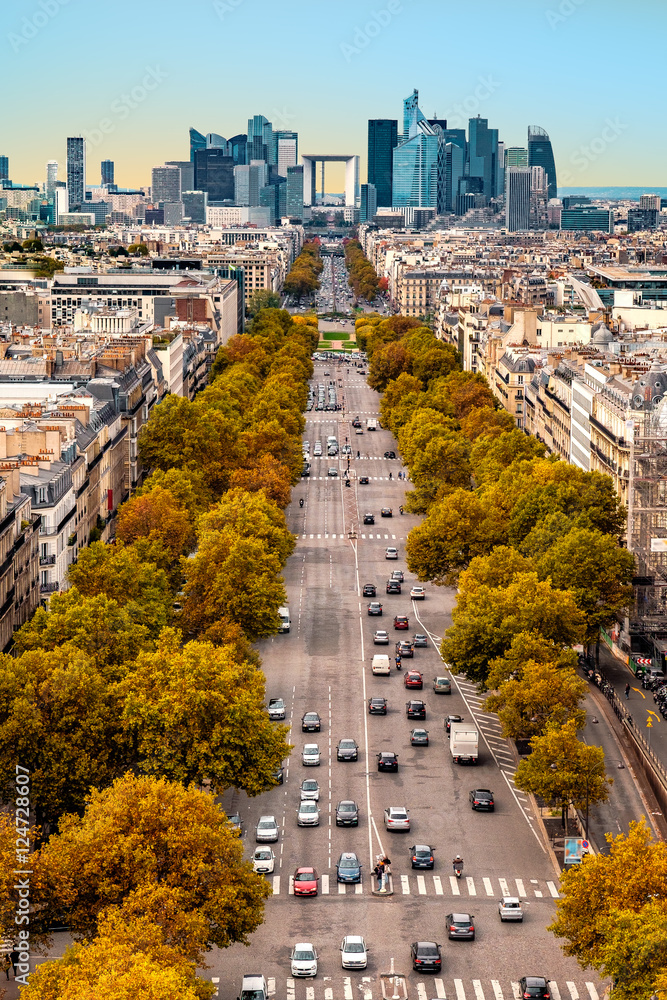 La Defense Financial District Paris France in autumn. Traffic on Champs-Elysees with orange and yellow trees aside. Modern vs. Old architecture