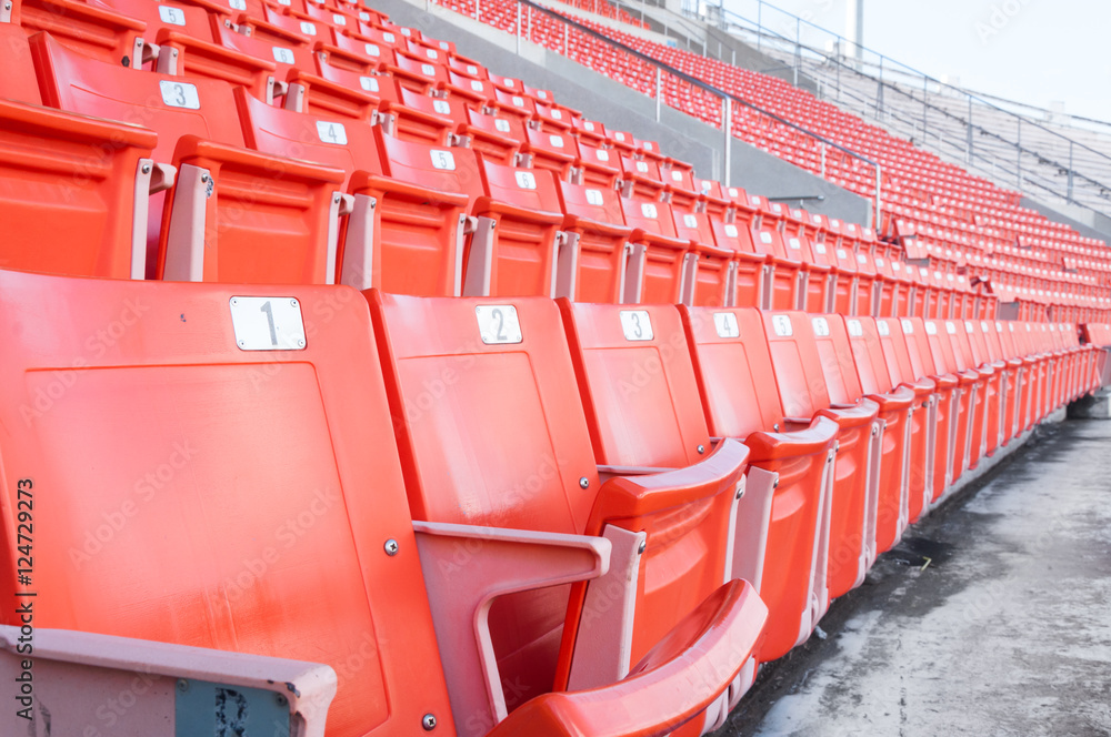 Fototapeta premium Empty orange seats at stadium,Rows of seat on a soccer stadium