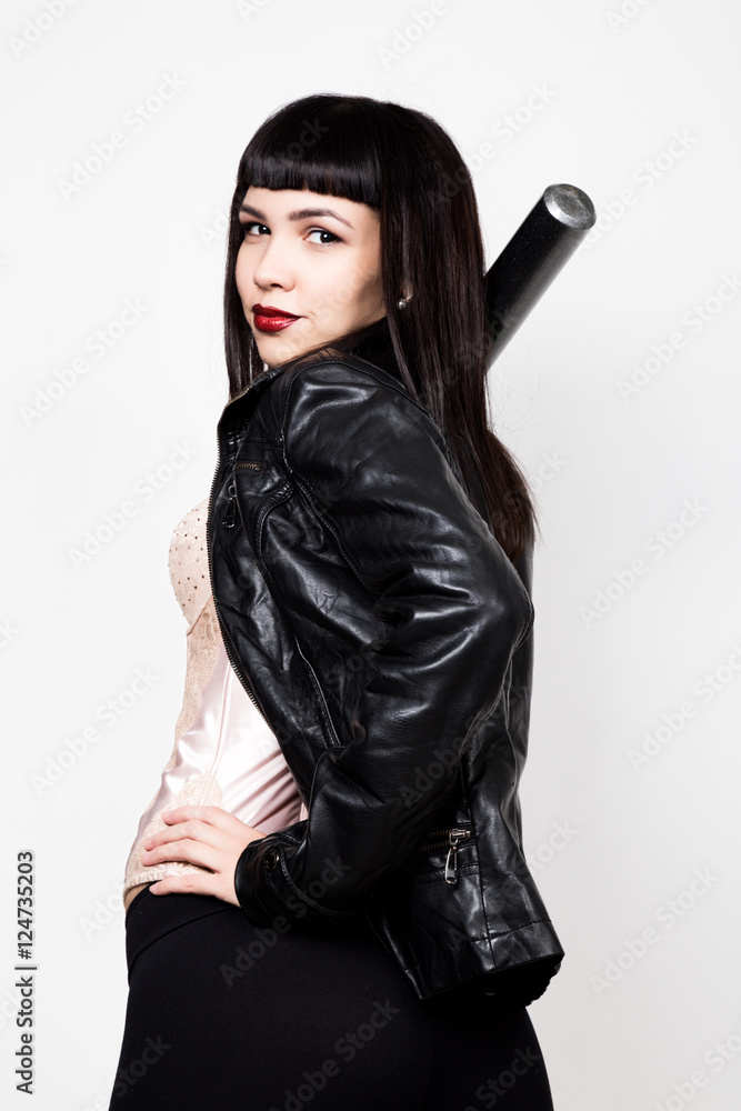 young beautiful woman in a leather jacket, posing with baseball bat. young beautiful woman in a leather jacket, posing with baseball bat.