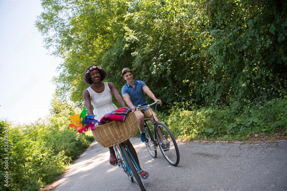 Obraz premium Young multiethnic couple having a bike ride in nature