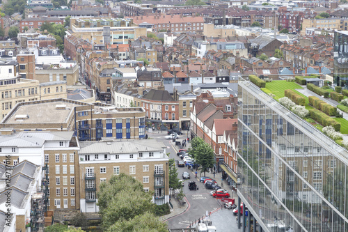 Photography Aerial view of east London busy urban district with densely built up houses, sho