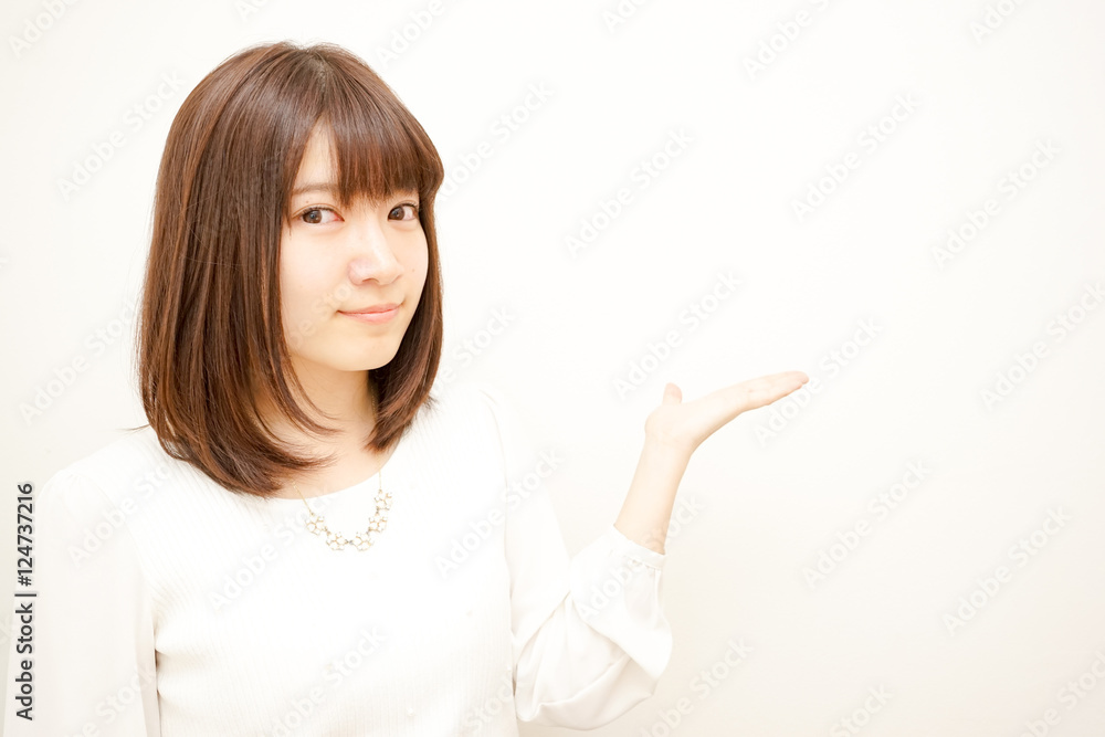 Young Japanese woman pointing something with smile Young Japanese woman pointing something with smile