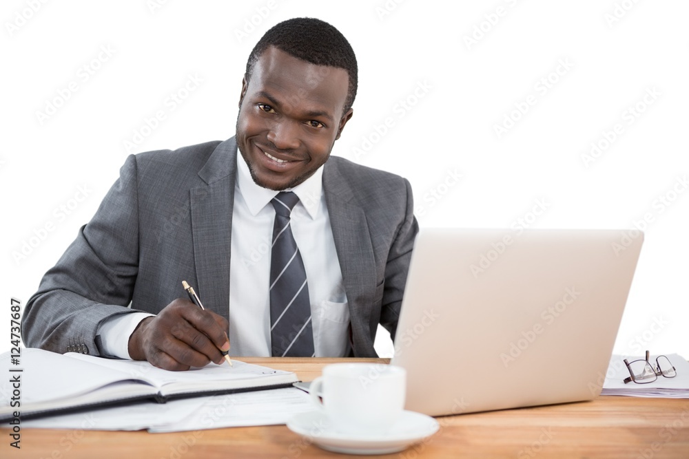 Happy businessman working at office desk Happy businessman working at office desk