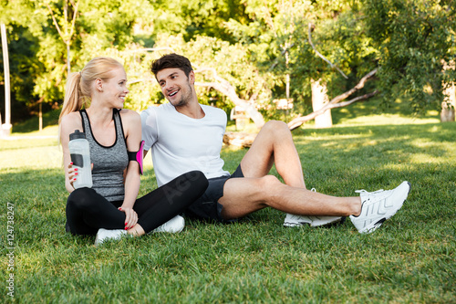 Sport fitness couple relaxing after training outdoor