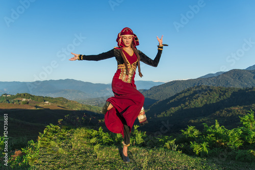 young woman dancing georgian national clothes mountains outdoors summer sunny photo