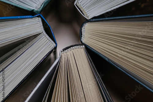 Several books stand together background 