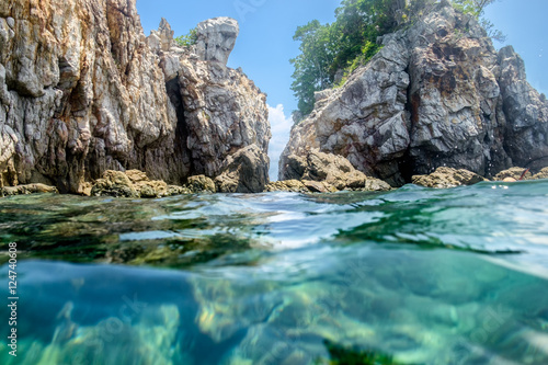 Cliff rock strait on emerald sea