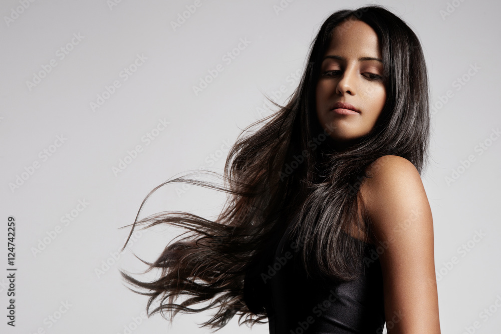 Obraz premium woman with healthy brunette hair in studio shoot