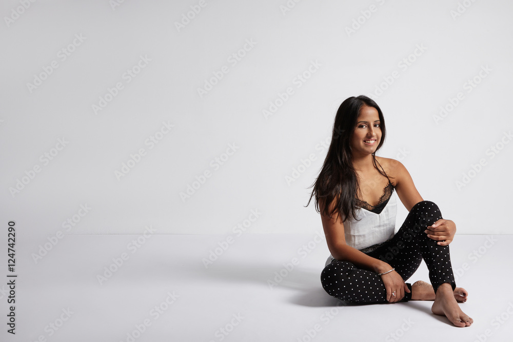 brunette woman sits on the floor and watching at camera brunette woman sits on the floor and watching at camera