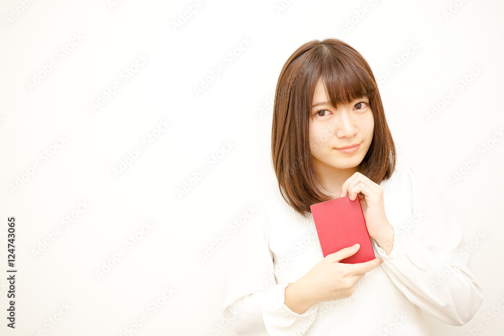 Young woman holding her passport with smile Young woman holding her passport with smile