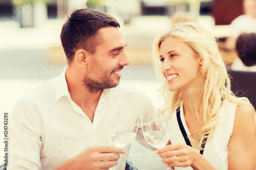 happy couple clinking glasses at restaurant lounge