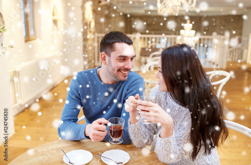 happy couple drinking tea at cafe