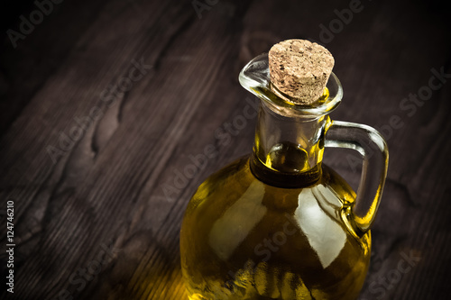 olive oil container bottle with stopper on wood table background