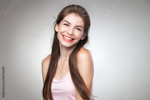 Portrait of smiling girl posing at camera.