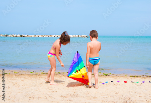 Children playing with a kite on beach