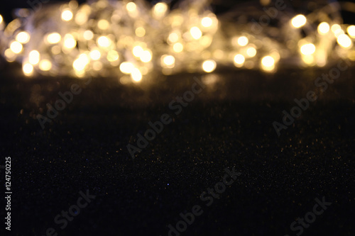 glitter vintage lights background. dark gold and black