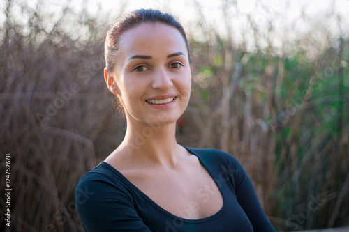 Young woman portrait with reeds on background