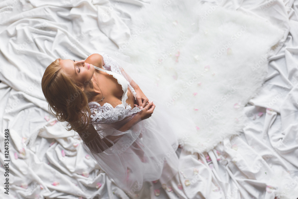 An Upper Sight Of A Young Sexy Girl Getting Undressed Her Eyes Closed Isolated In White Cloth 