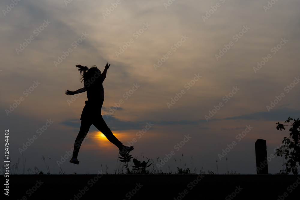 Silhouette girls on holiday. she is happy to be running and jump Silhouette girls on holiday. she is happy to be running and jump