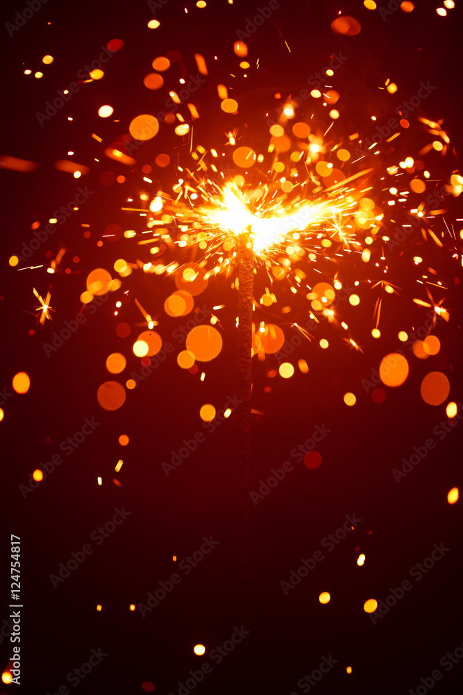 Christmas sparkler in haze with red light Christmas sparkler in haze with red light
