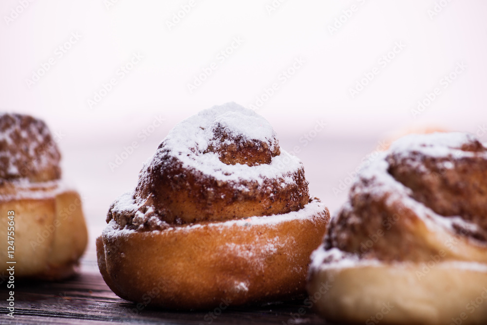 Cinnamon bun on wood background Cinnamon bun on wood background