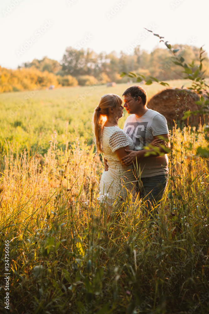 love story man and woman on the background of haystacks sun love story man and woman on the background of haystacks sun