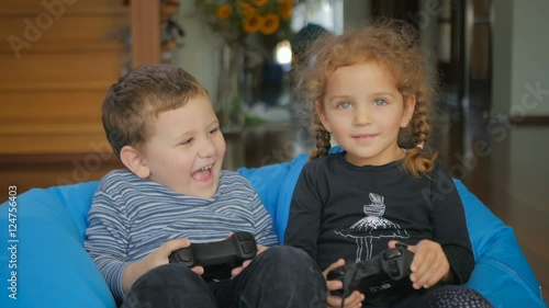 Cute boy and girl playing a game on the x-box