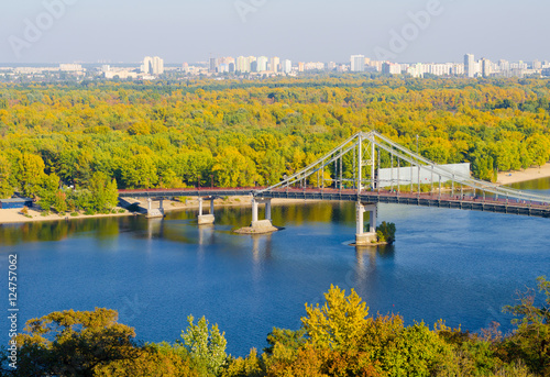 Pedestrian bridge over a cloudy sky Dnieper River in Kiev
