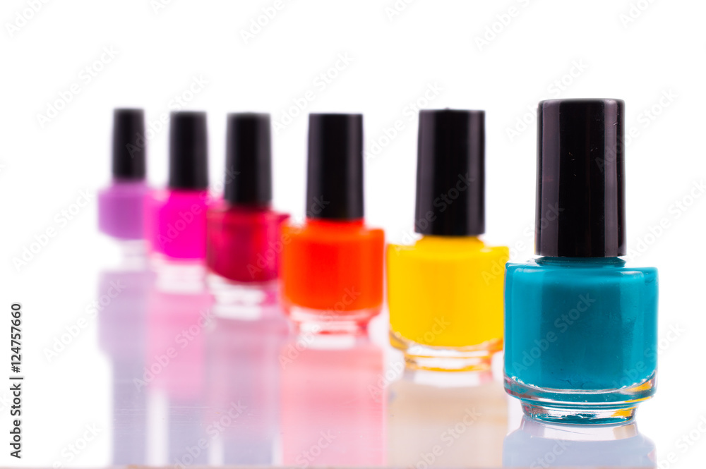Many multi-colored nail polish. On white, isolated background.Macro. Close up. Many multi-colored nail polish. On white, isolated background.Macro. Close up.