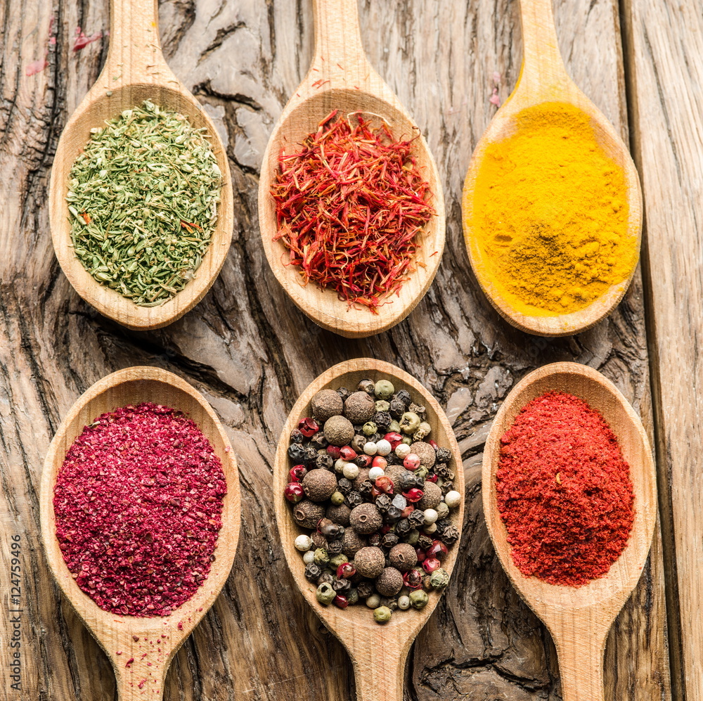 Fototapeta premium Assortment of colorful spices in the wooden spoons.