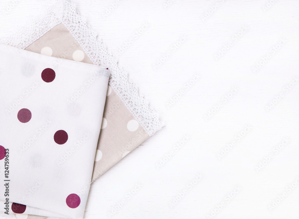 Two napkins with polka dots on white wooden table. Top view Two napkins with polka dots on white wooden table. Top view