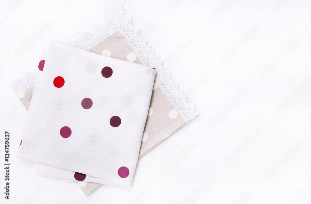 Two napkins with polka dots on white wooden table. Top view Two napkins with polka dots on white wooden table. Top view