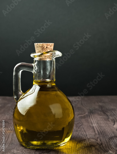 olive oil container bottle with stopper on wood table background