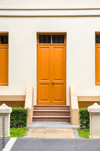 orange Door , orange window on Cream Wall on orange staircase wi