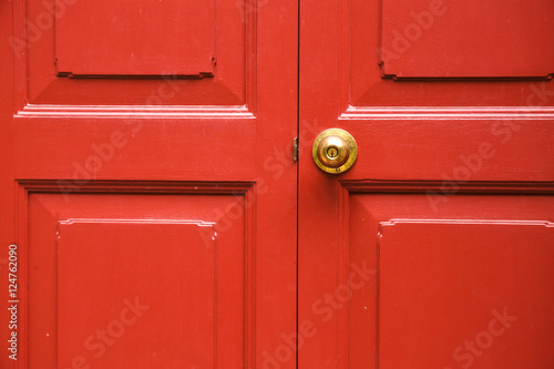 Door knob golden color with red door background