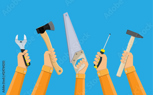 hands of workers holding building tools