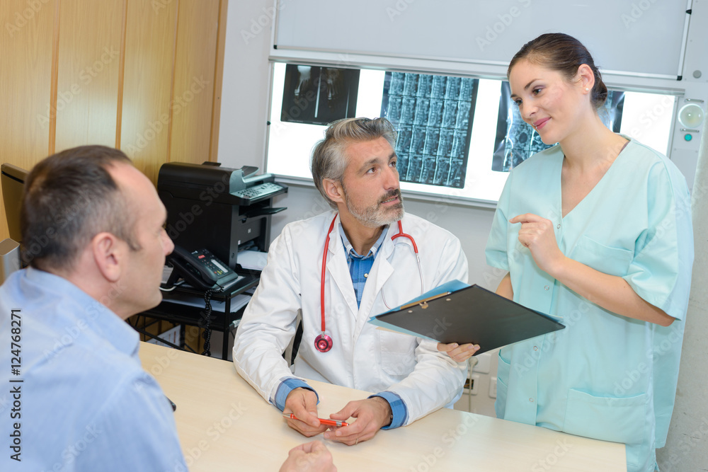 Medical staff giving results to patient Medical staff giving results to patient