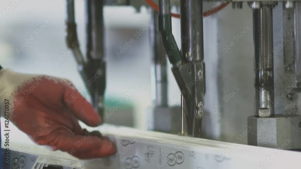 Milling the drainage holes of plastic windows. Factory Work on the ...