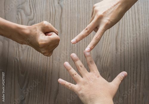 Closeup of hands making sign as rock paper and scissors