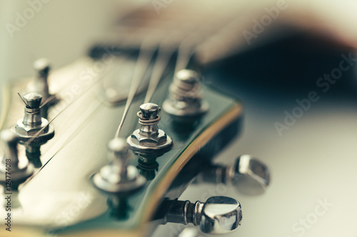 Electric guitar body and neck detail on wooden background