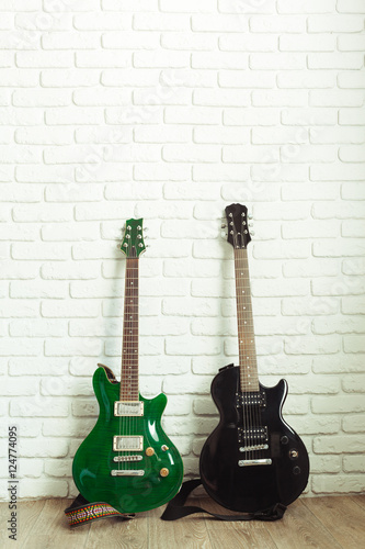 Electric guitar body and neck detail on wooden background © fotofabrika